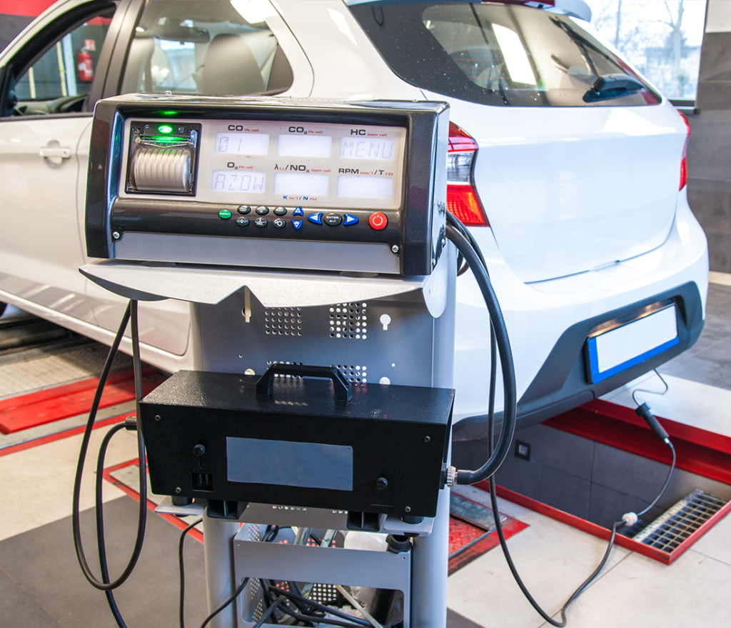 A car receiving a smog test service with the testing display showing.